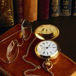 Old books, pocket watch and glasses
