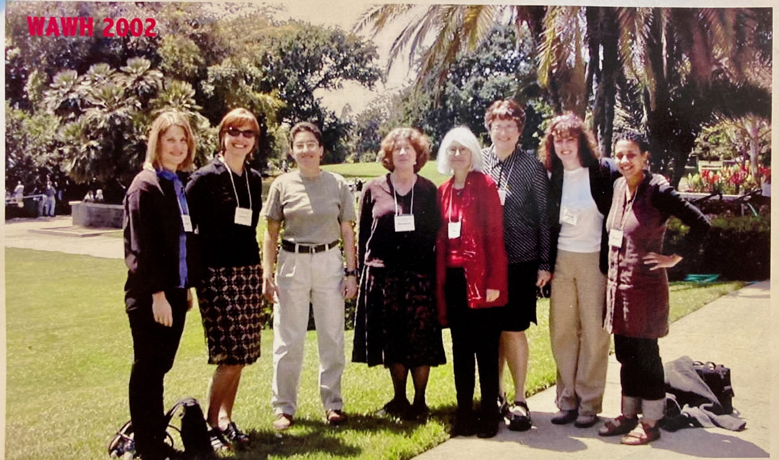 8 women standing together looking at the camera